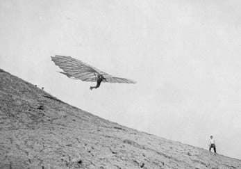 Otto Lilienthal leaping from a hill with his hang glider.